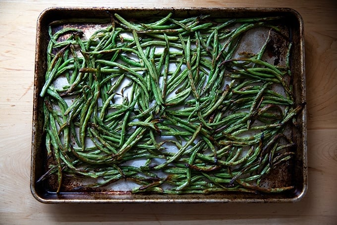 Roasted green beans on a sheet pan.
