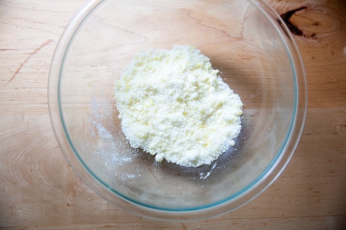 A bowl of lemon and sugar mixed together.