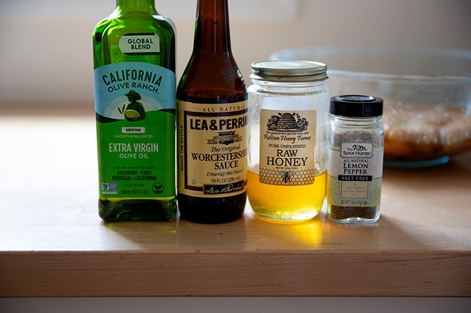 Ingredients to make the grilled chicken breast marinade: olive oil, Worcestershire sauce, honey, lemon pepper.