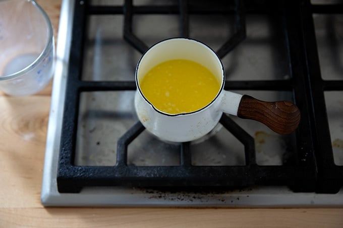 A small pot of butter on the stovetop.