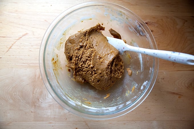 A bowl of just-mixed gingerbread cookie bar dough in a large bowl.