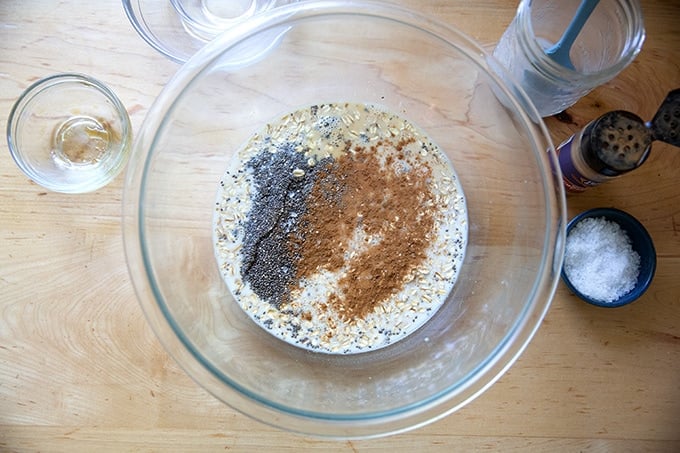 A large bowl filled with the ingredients to make overnight chia oats not yet mixed together.
