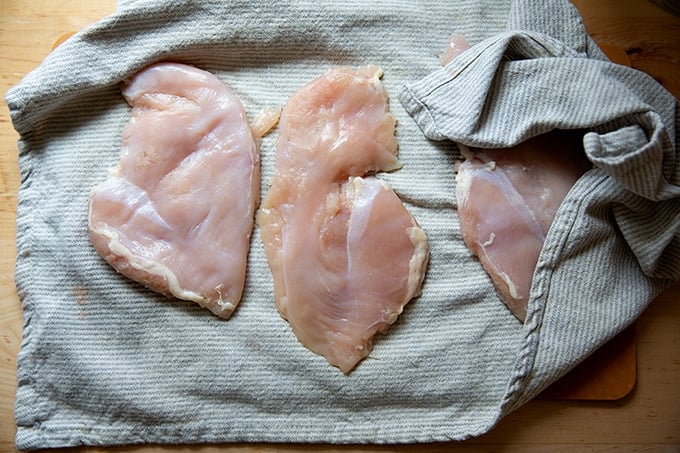 Chicken breasts drying in a tea towel.
