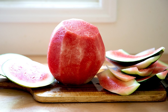 A peeled watermelon on a countertop.