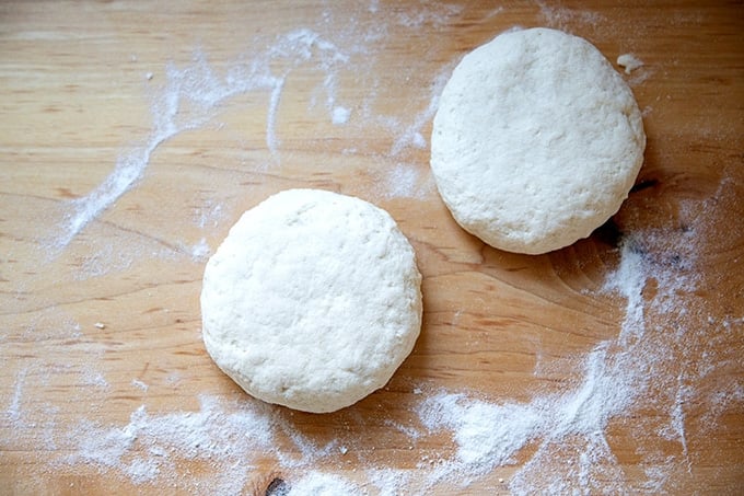 Two rounds of gluten-free pizza dough on a countertop.