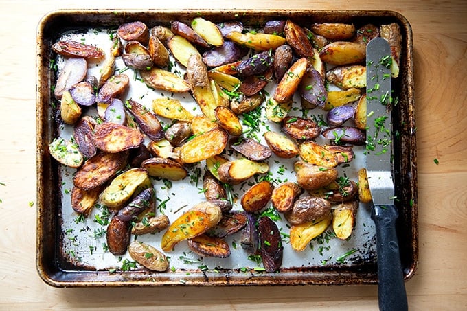 Herbed roasted fingerling potatoes on a sheet pan.