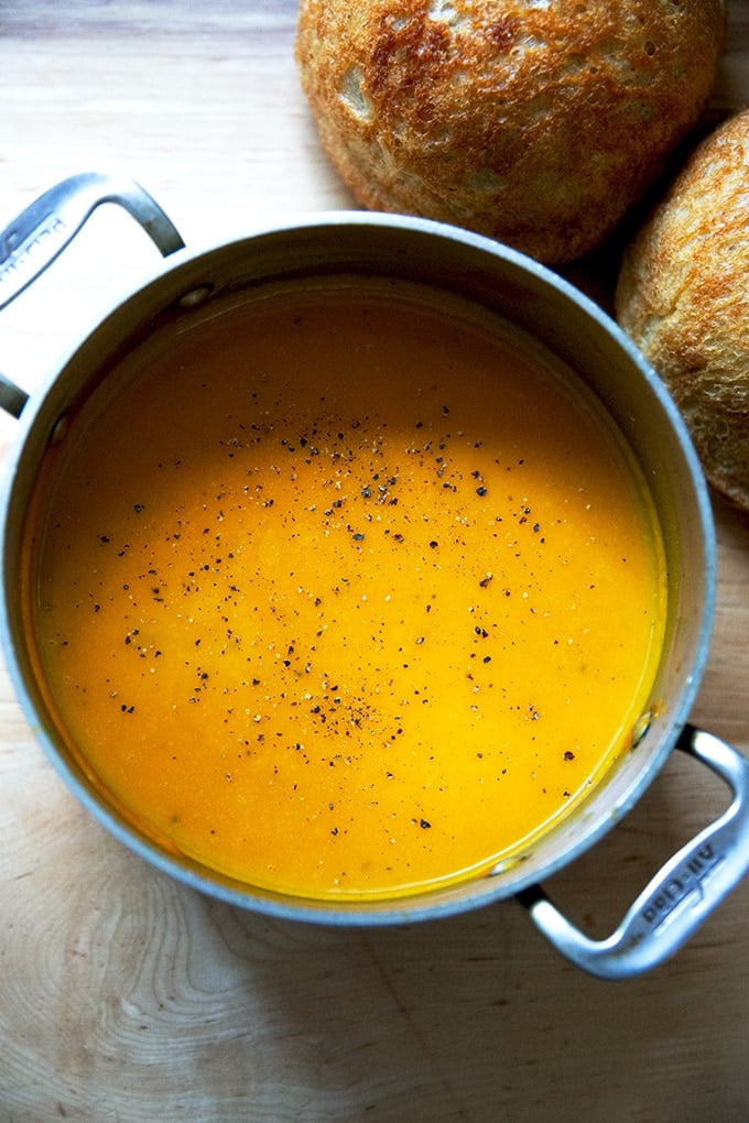 A pot of roasted butternut squash and garlic soup.