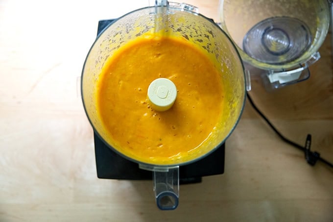 Pureed yellow tomato sauce in a food processor.