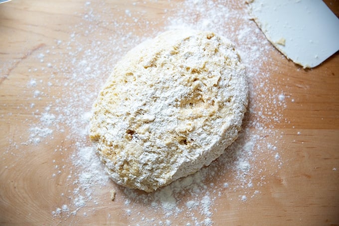 Hot cross bun dough turned out onto a floured counter top.