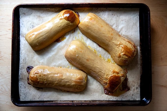 Halved roasted butternut squash on a sheet pan, - 5