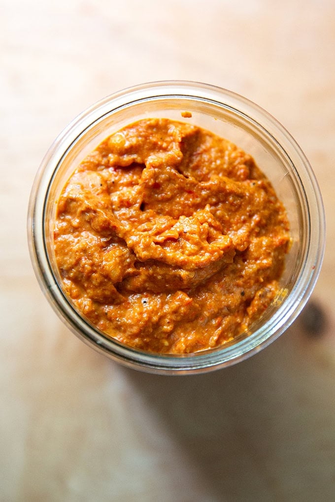 Homemade romesco sauce in a glass jar.