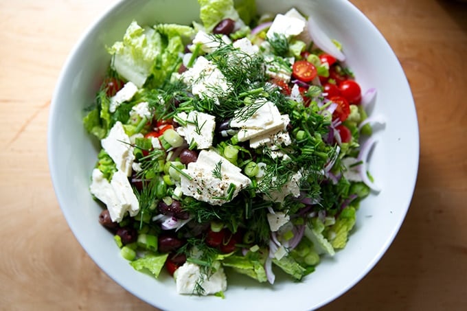 A bowl of untossed Greek salad.