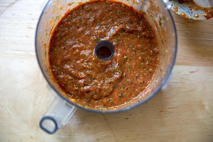 A food processor filled with blistered tomato salsa. - 8