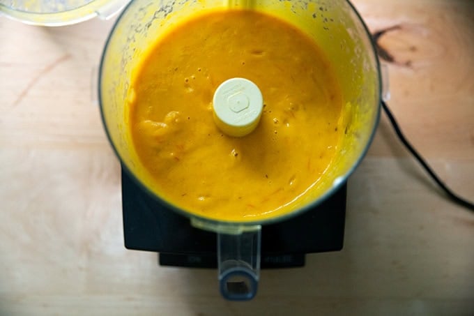 Puréed yellow tomato sauce in a food processor.