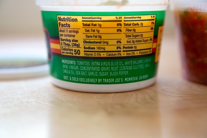 A tub of Trader Joe's bruschetta sauce highlighting the ingredient list.