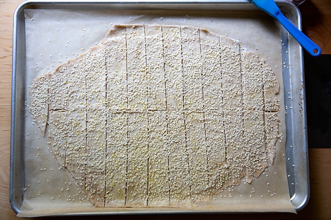 Unbaked sourdough crackers on a sheet pan.