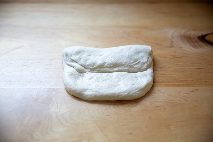 A round of baguette dough folded envelope style.