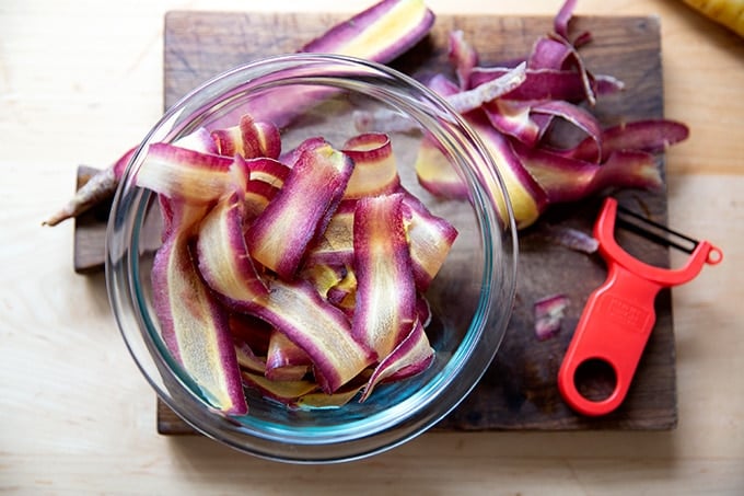 Thinly shaved carrots in a bowl.