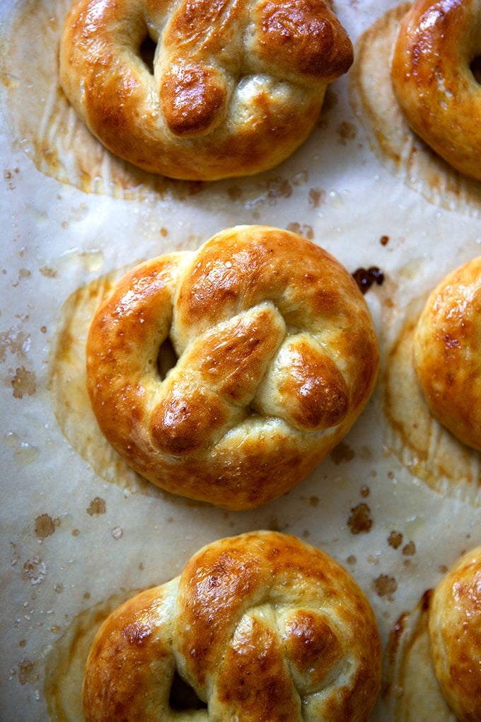 Just-baked soft pretzels on a sheet pan.