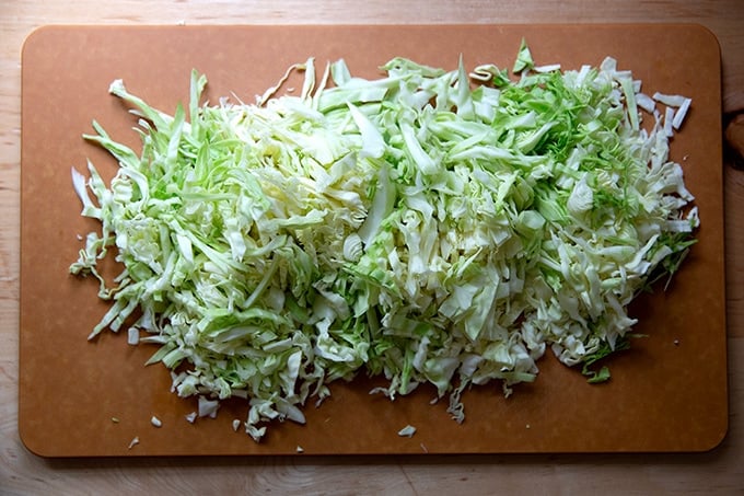 Shredded cabbage on a cutting board.