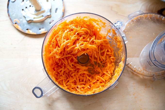Shredded carrots in a food processor.