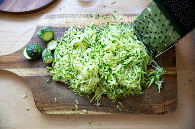 Shredded zucchini on a cutting board.