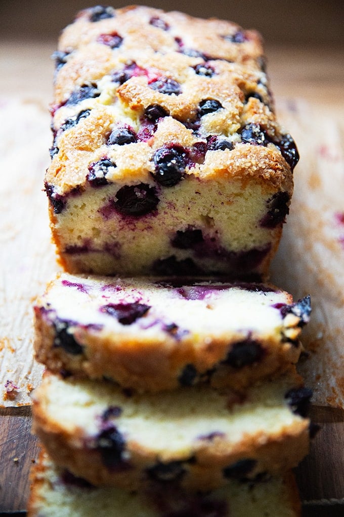 Sliced lemon-blueberry quick bread on a board.