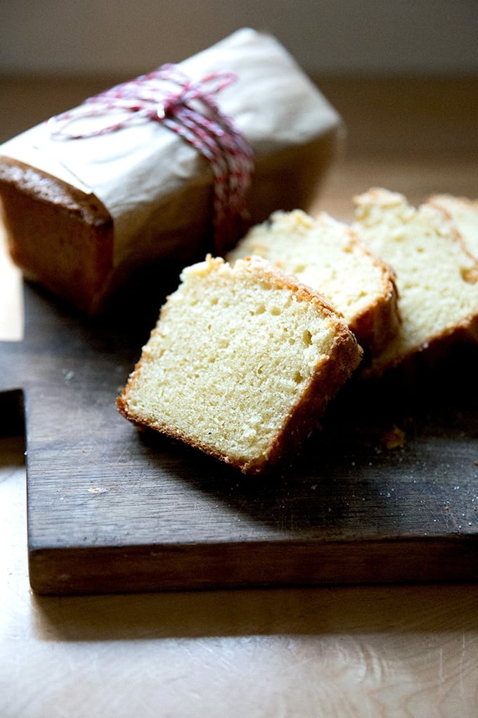 A sliced loaf of pound cake on a board.