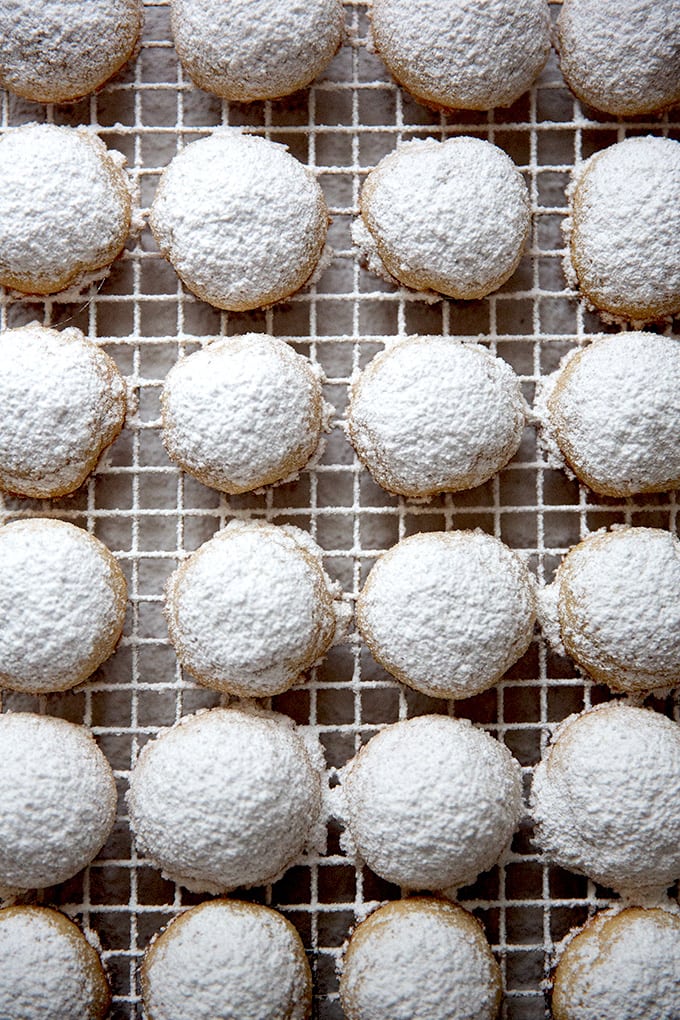 Lemon-almond snowball cookies cooling on a cooling rack. 