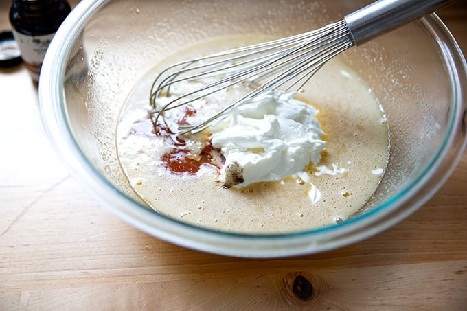 A large bowl filled with the ingredients to make pound cake.