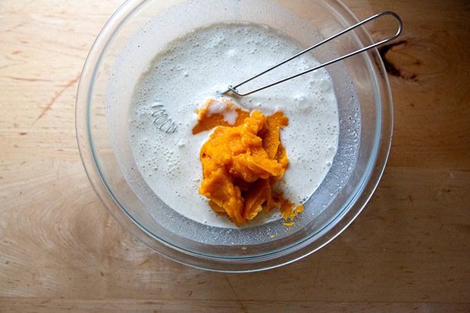 A large bowl filled with the filling ingredients for roasted butternut squash pie. - 10