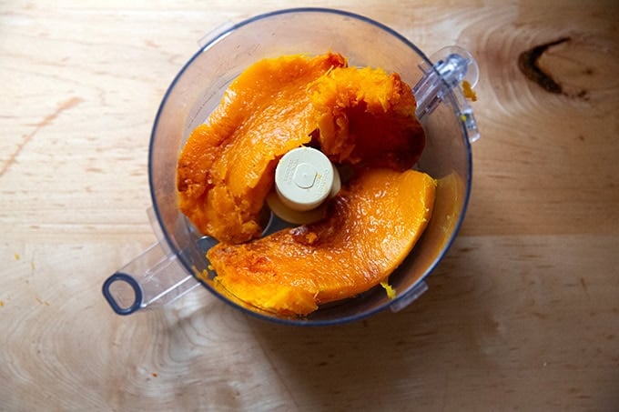A food processor filled with roasted butternut squash. - 6
