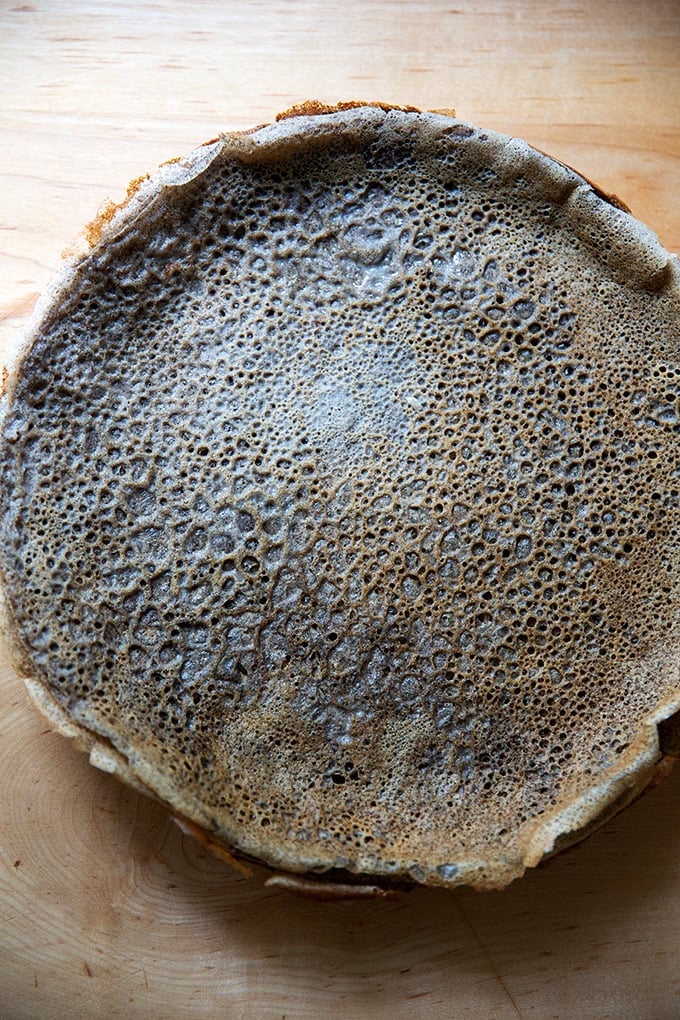 A stack of cooked buckwheat crepes on a plate.