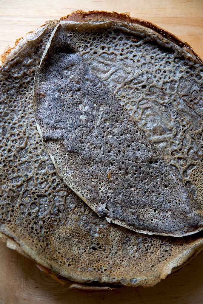 A stack of cooked buckwheat crepes on a plate.