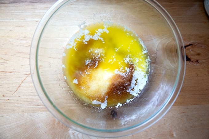 A large bowl filled with sugar, butter, and salt.