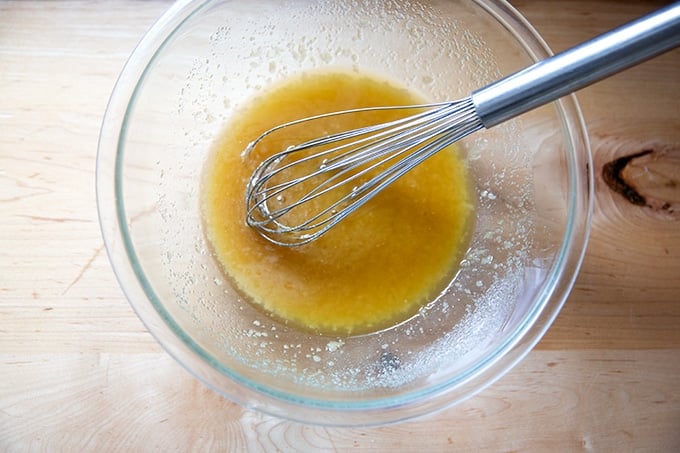 A large bowl filled with whisked butter and sugar.