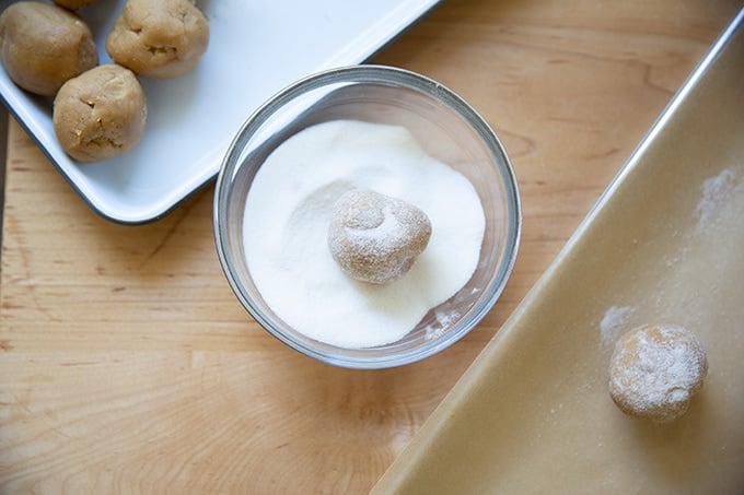A peanut butter cookie dough ball coated in sugar.