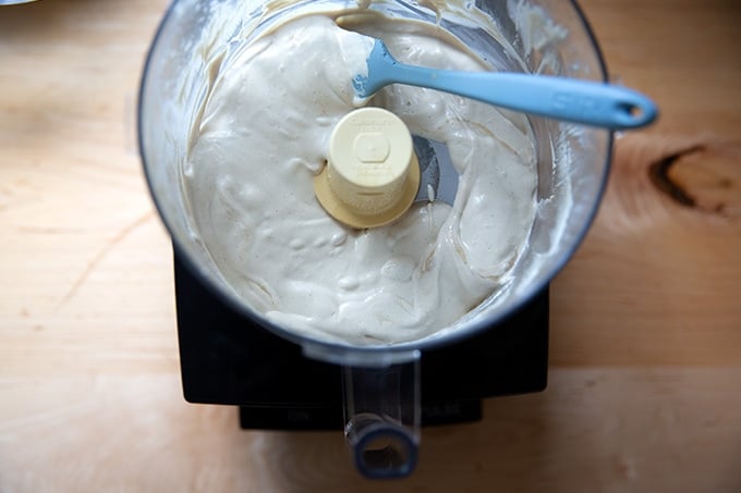 Puréed tahini sauce in a food processor.