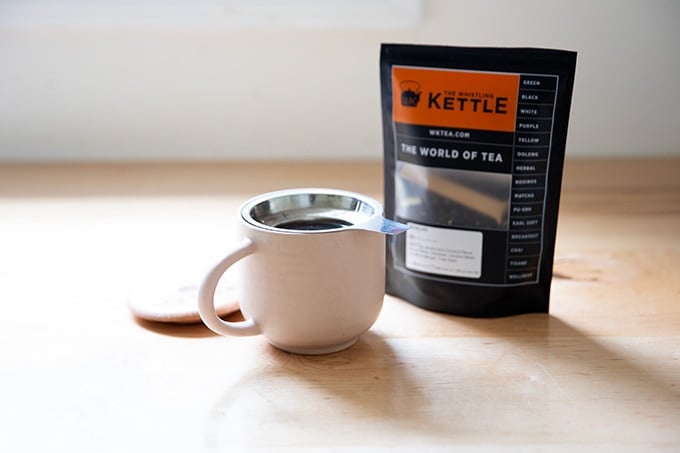 A cup of tea on a countertop.