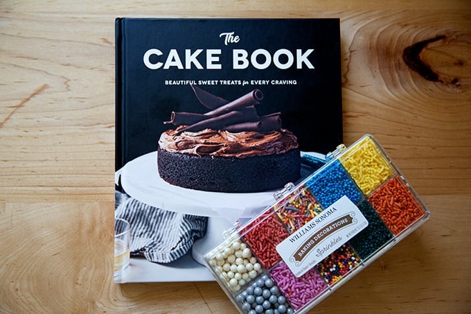 The Cake Book with a box of sprinkles.