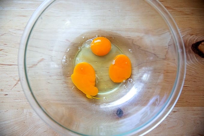 Three eggs in a large bowl.