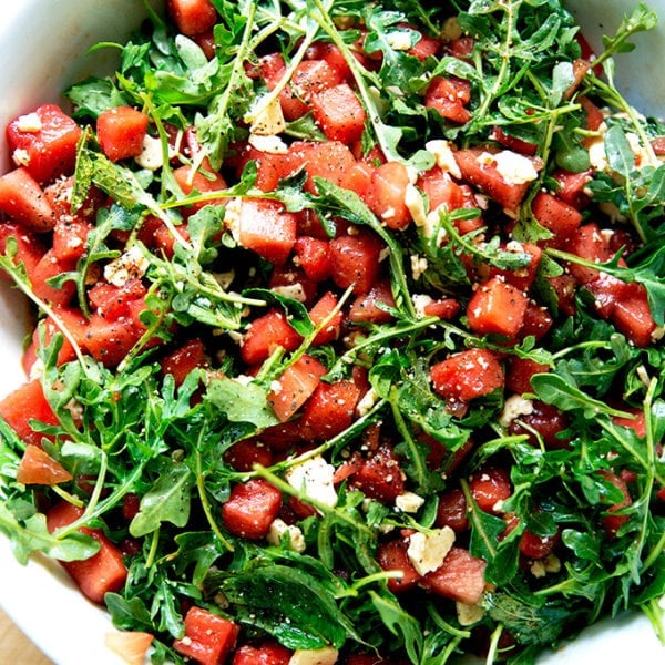 A tossed watermelon and feta salad in a bowl.