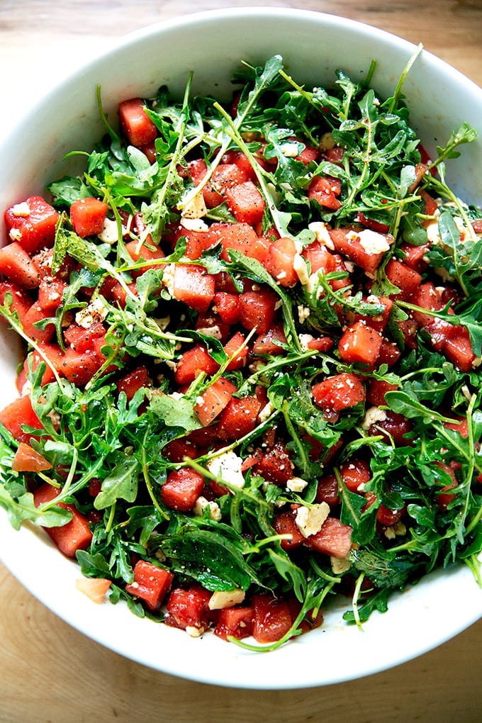 A tossed watermelon and feta salad in a bowl.