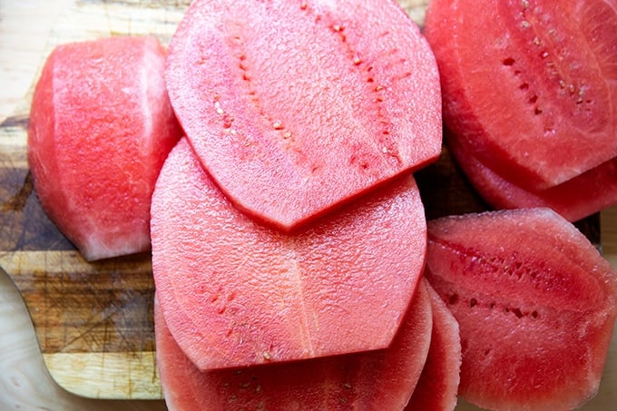 Slabs of watermelon on a cutting board.