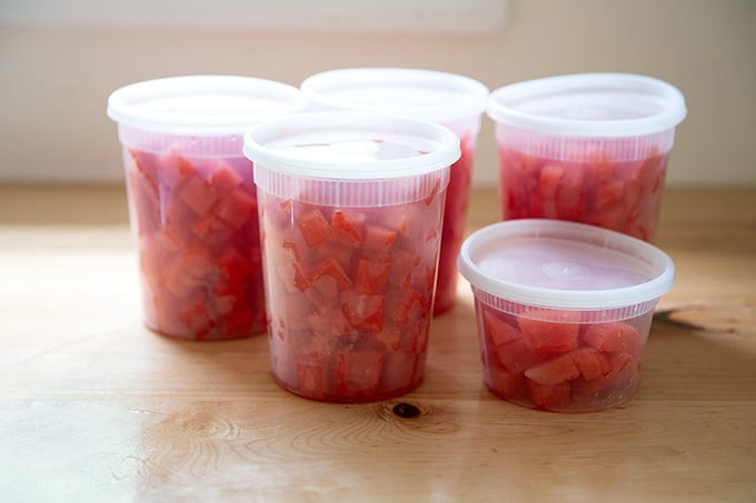 Cubes of watermelon in quart containers.