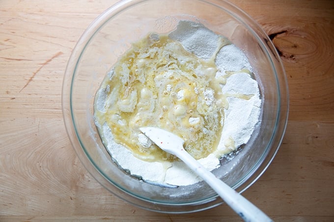 The wet ingredients added to the dry ingredients for a flag cake.