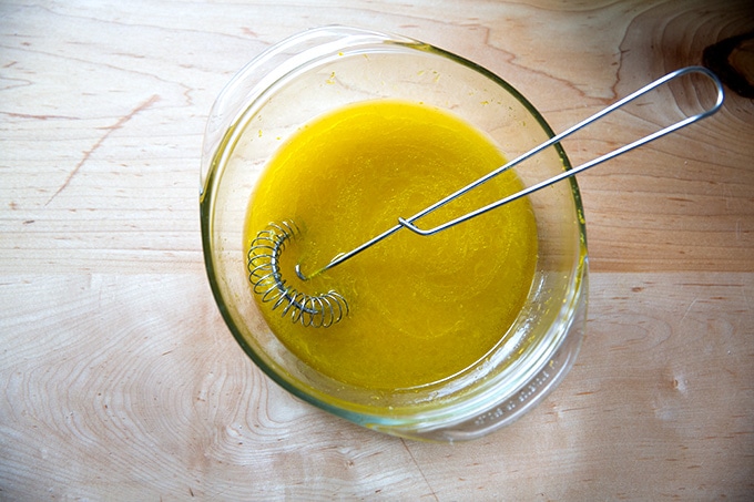Wet ingredients for orange and olive oil cake whisked together in a bowl.