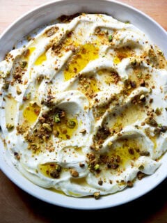 A platter of whipped ricotta with honey, olive oil, and pistachios.