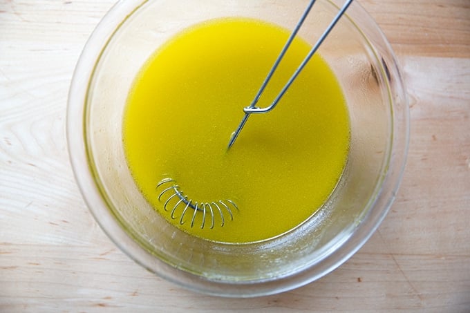 A bowl of whisked lemon vinaigrette.