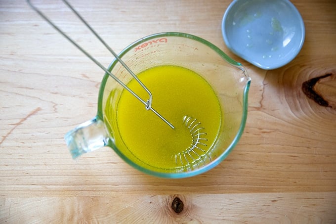 Whisked apple cider vinaigrette in a Pyrex liquid measure.